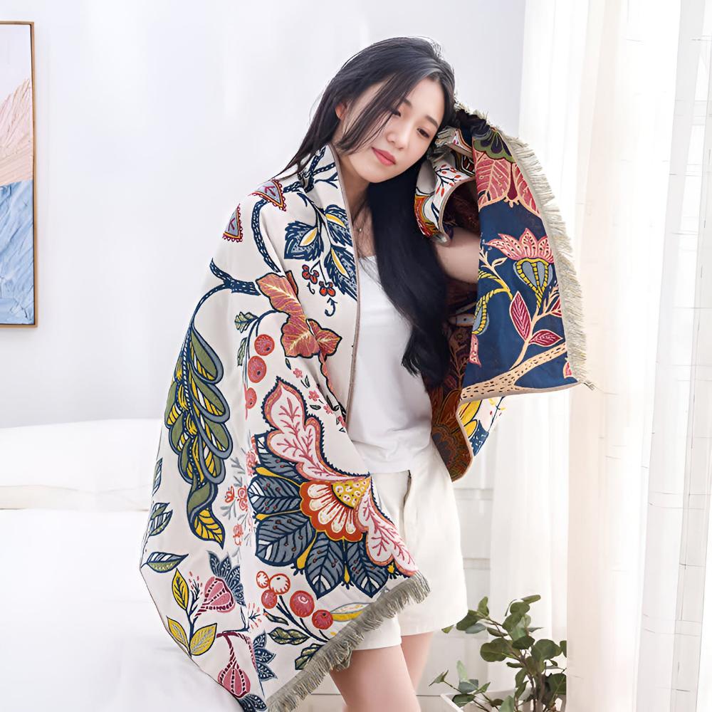 Woman wrapped in a reversible cotton bath towel with a vibrant floral print.