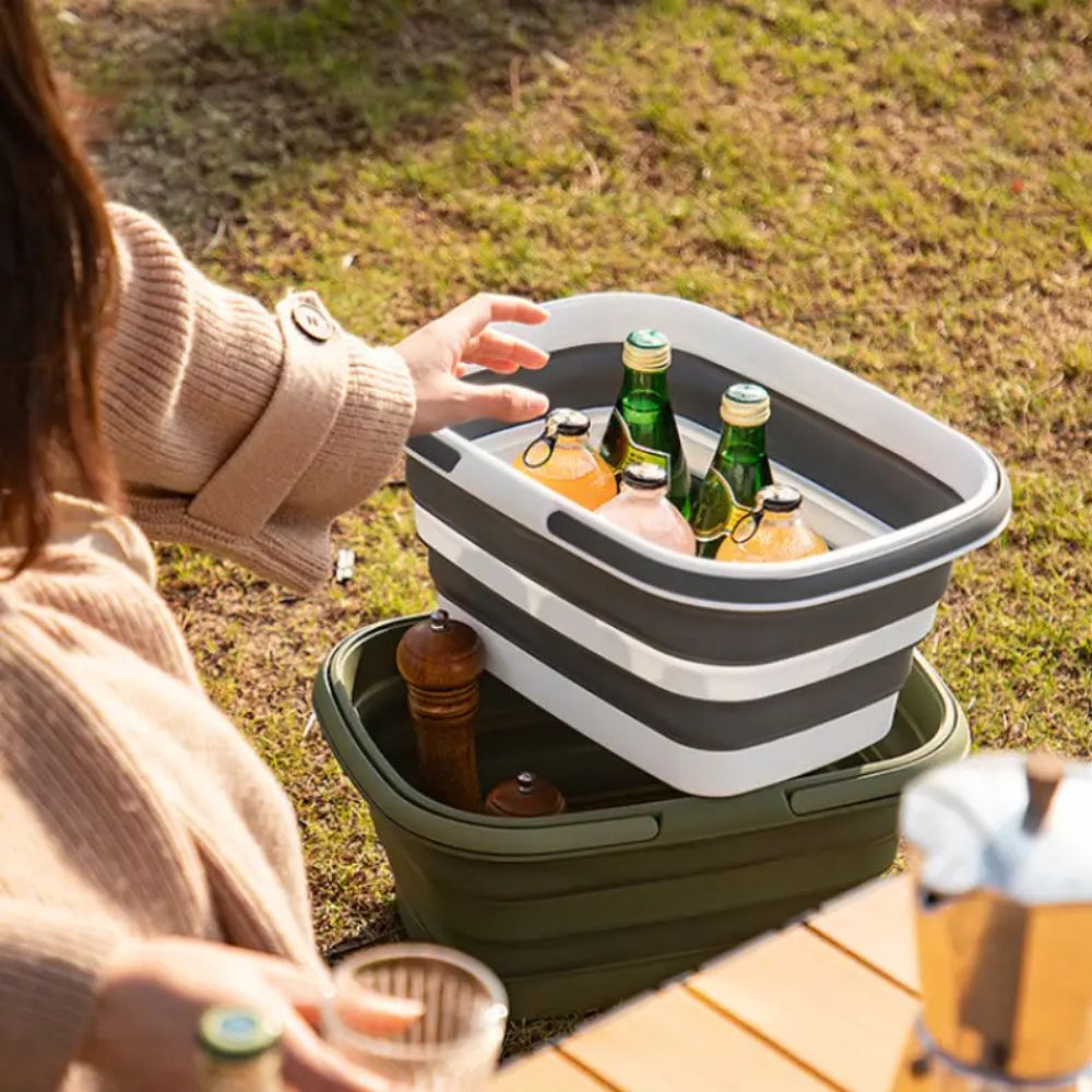 Collapsible storage basket with drinks and ice, stacked on another basket.