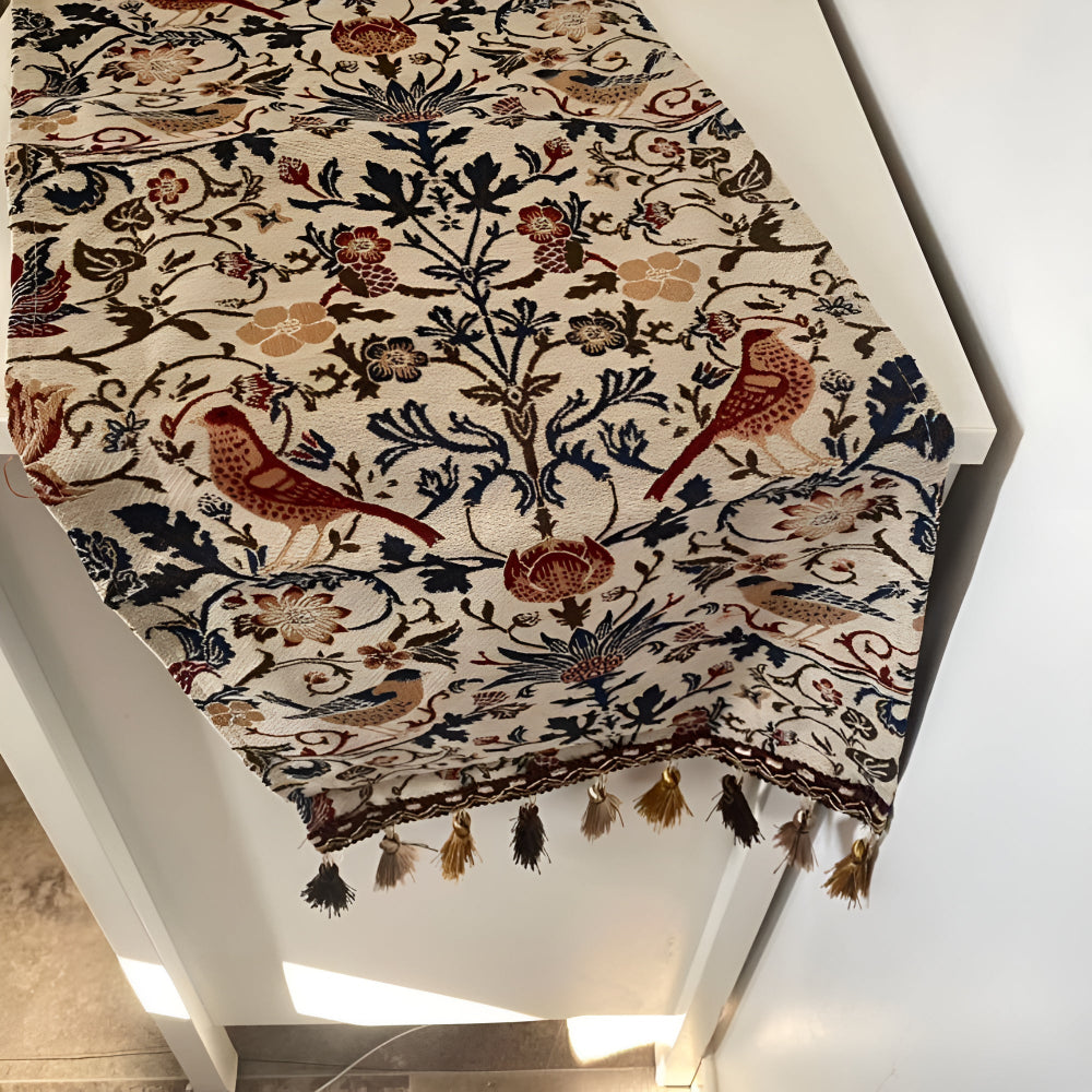 Vintage floral and bird jacquard table runner with tasseled ends.