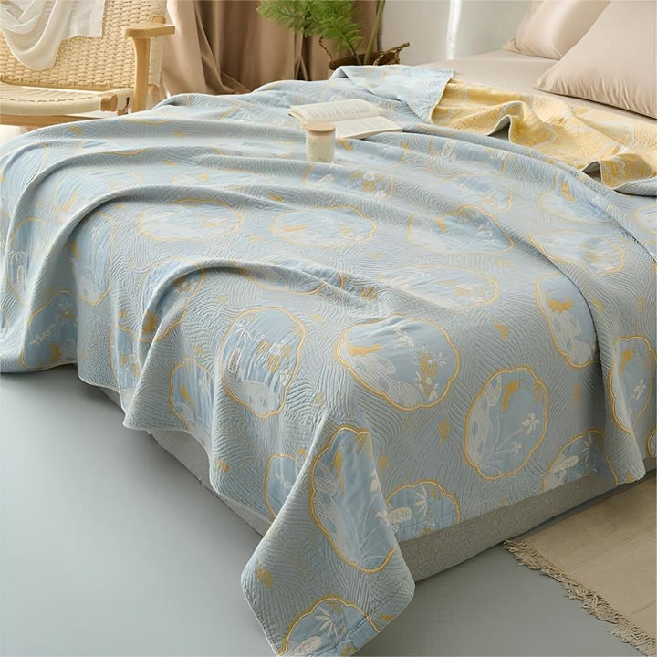 Light blue reversible blanket with a repeating pattern of white and yellow floral motifs.