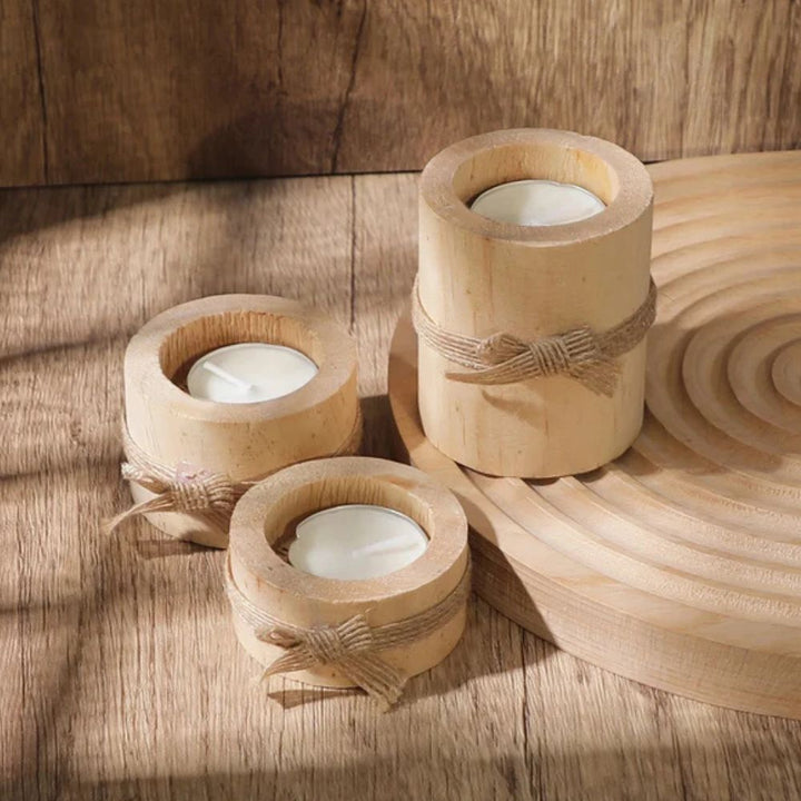 Set of three handcrafted bamboo candle holders with tea lights and jute twine bows.