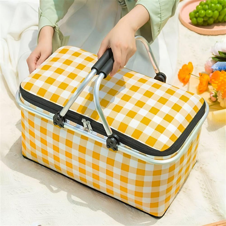 Yellow and white checkered insulated picnic basket with a silver frame and black handles.