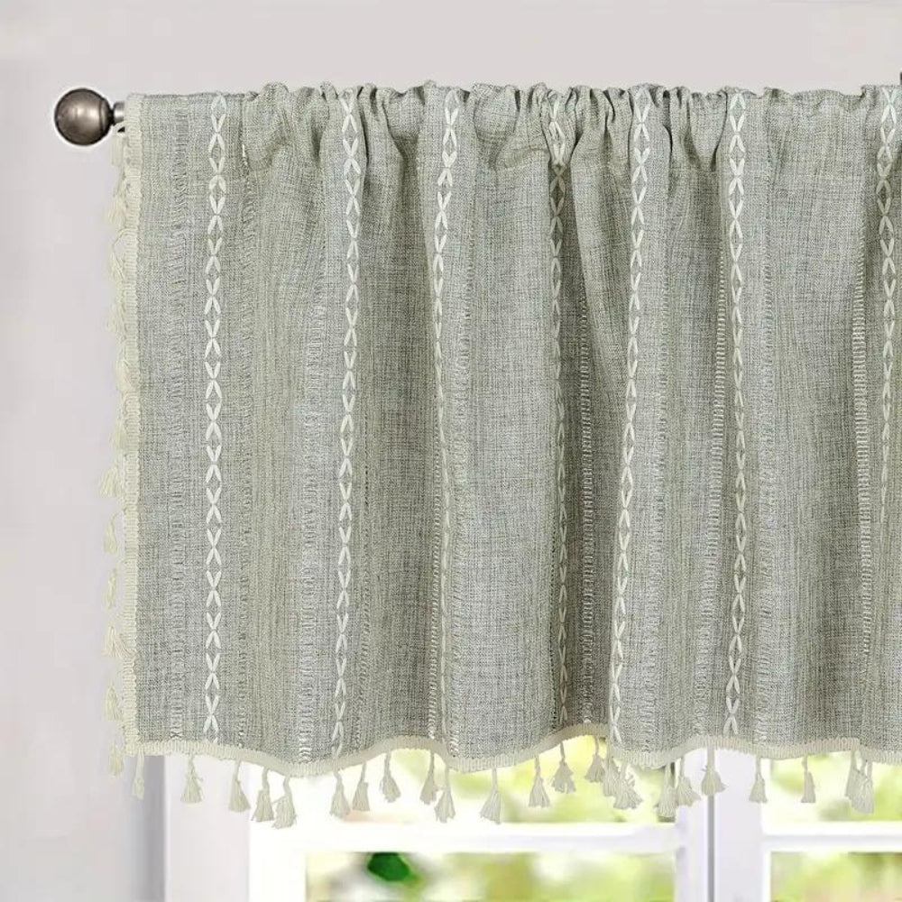 Grey cotton-linen kitchen valance with white embroidered stripes and tassels.