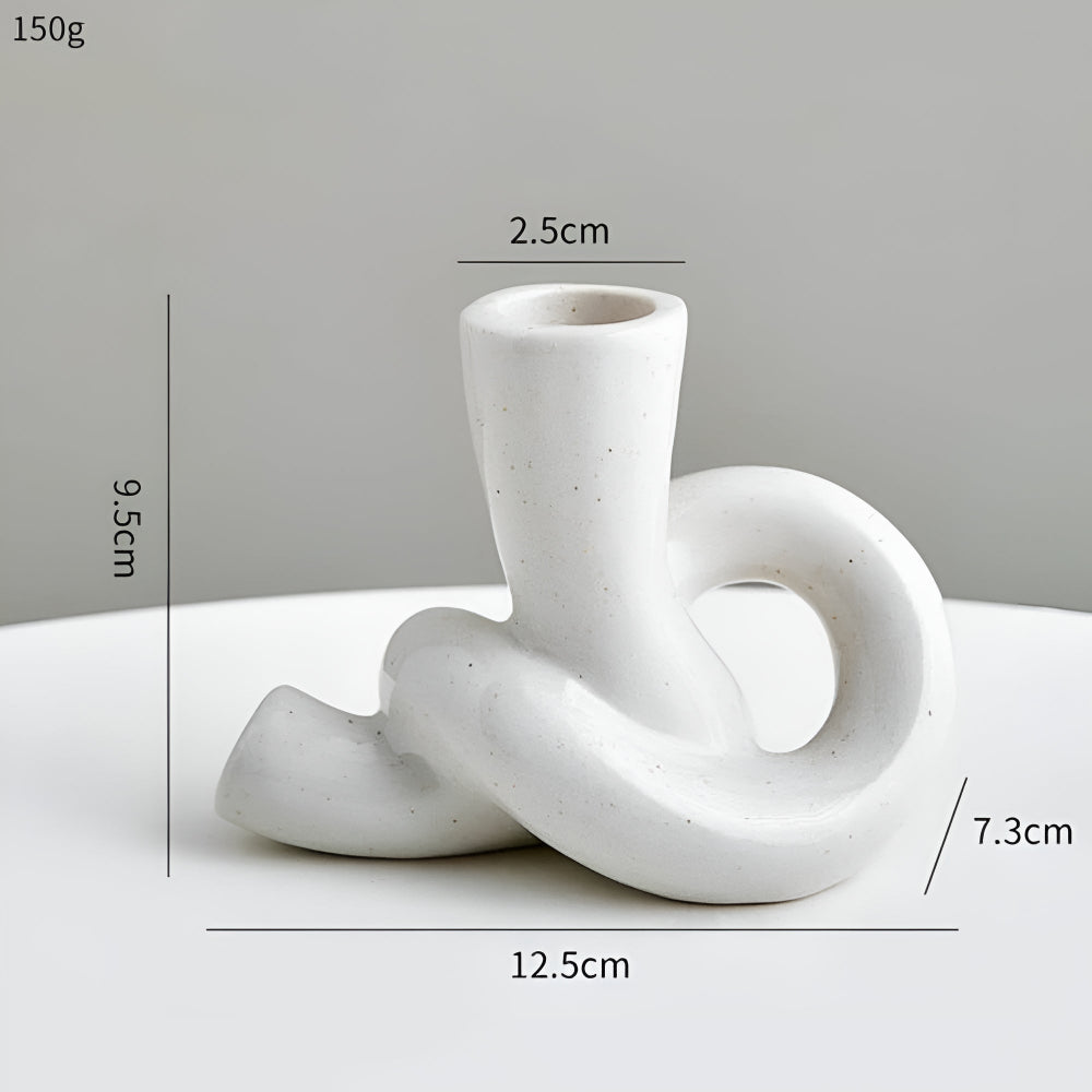 White ceramic knot candle holder, 9.5cm tall, 12.5cm wide, 7.3cm base, 2.5cm opening.