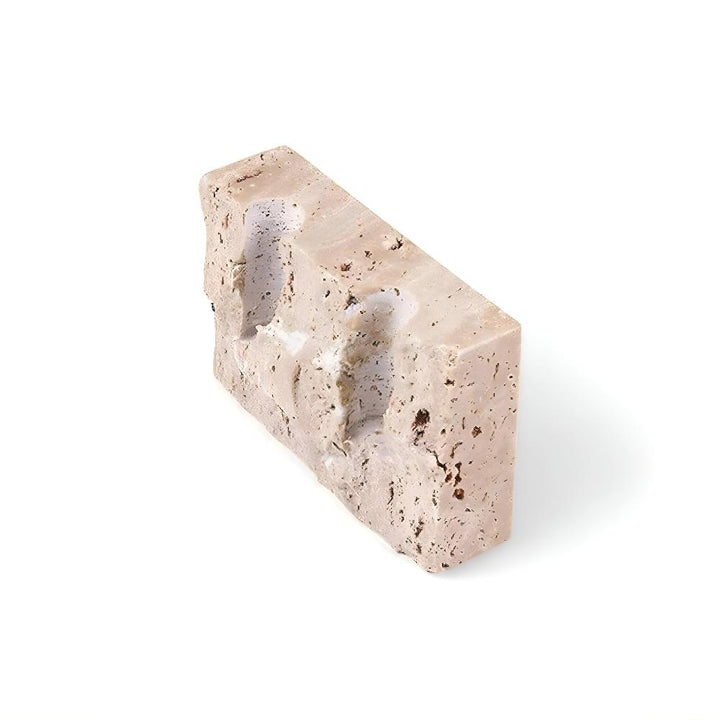 Travertine stone candle stand with two indentations for taper candles.