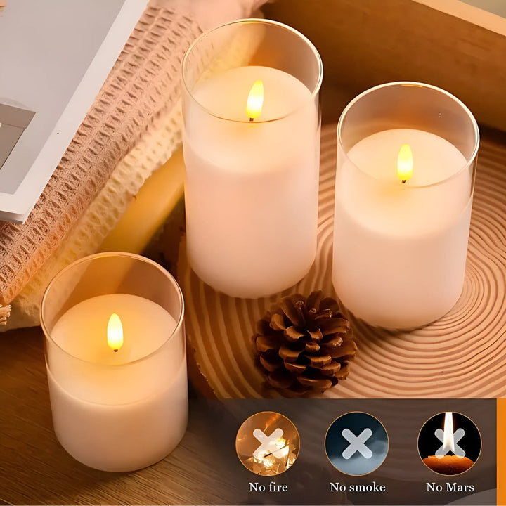Three white flameless LED candles in glass holders with realistic 3D flames.