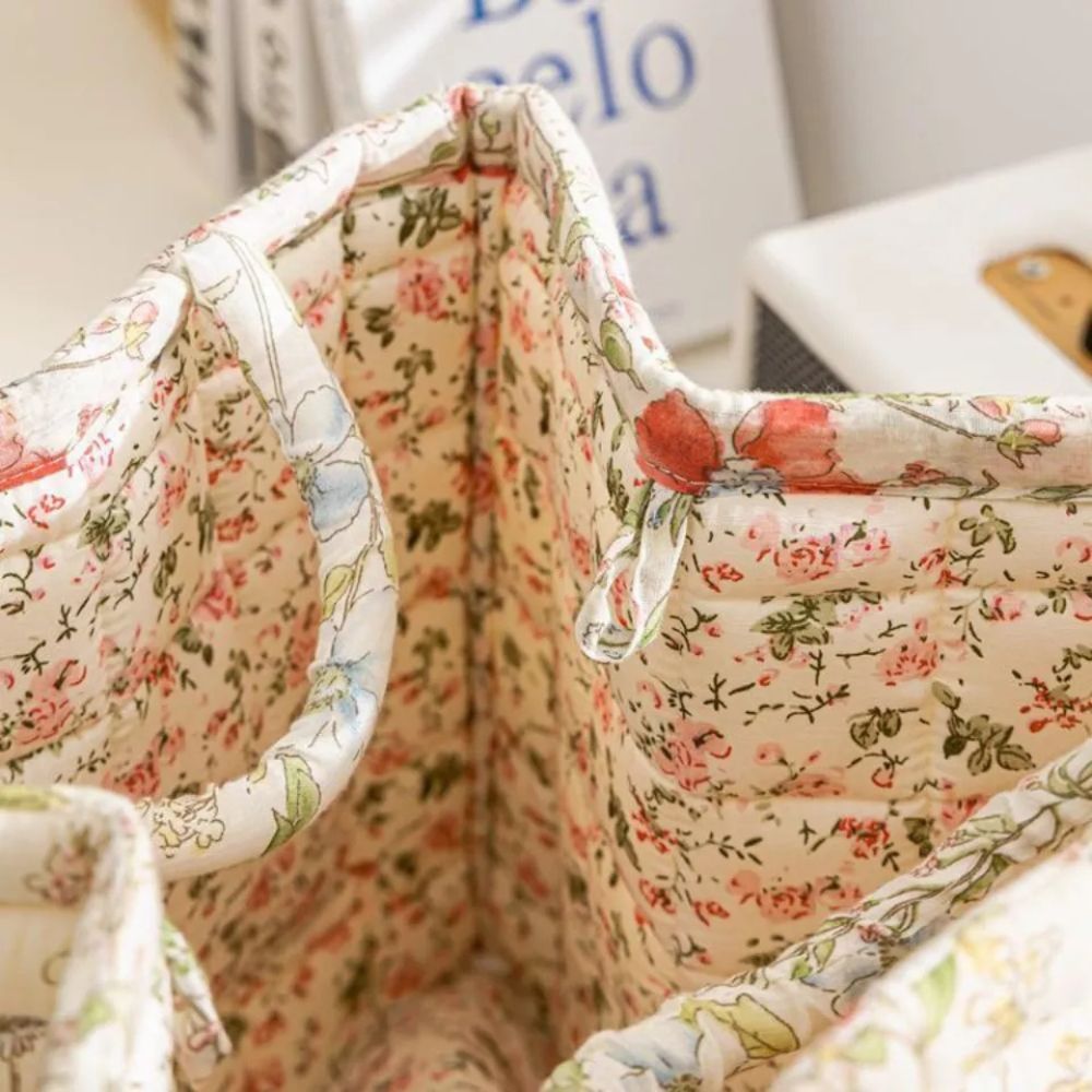 Interior view of a canvas storage basket with a delicate floral pattern and reinforced handles.