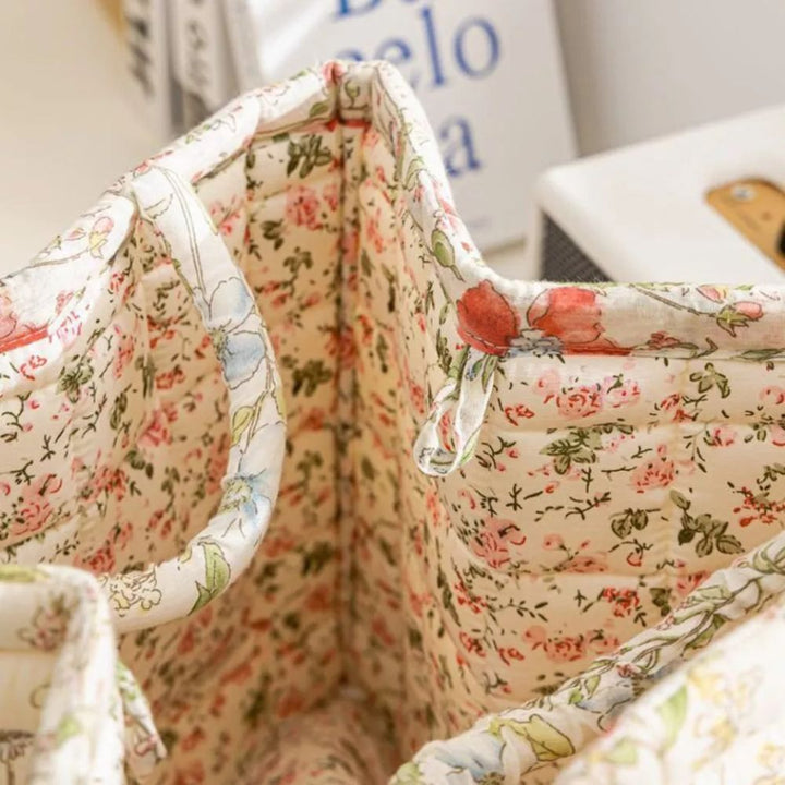 Interior view of a canvas storage basket with a delicate floral pattern and reinforced handles.