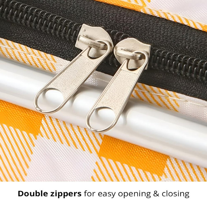 Close-up of two silver zipper pulls on a checkered picnic basket.