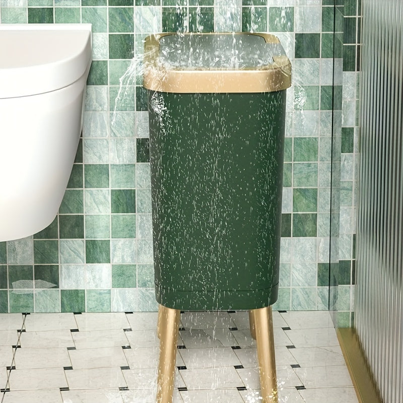 Dark green 15L elevated trash can with gold legs and lid, with water splashing on it.