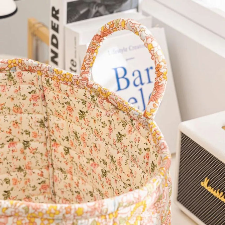 Delicate floral canvas storage basket with a handle, showing the interior floral pattern.