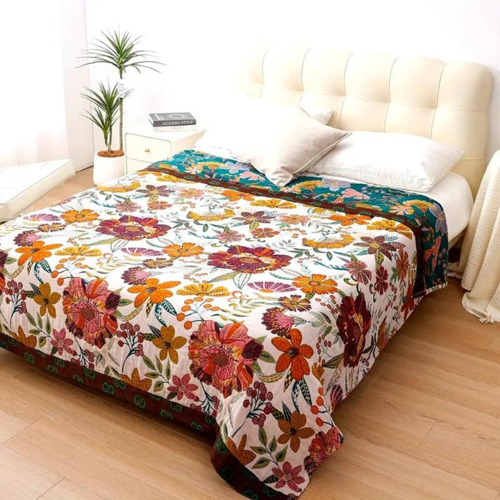 Charm floral blanket throw with a white base and colorful floral patterns in red, orange, yellow, and green.