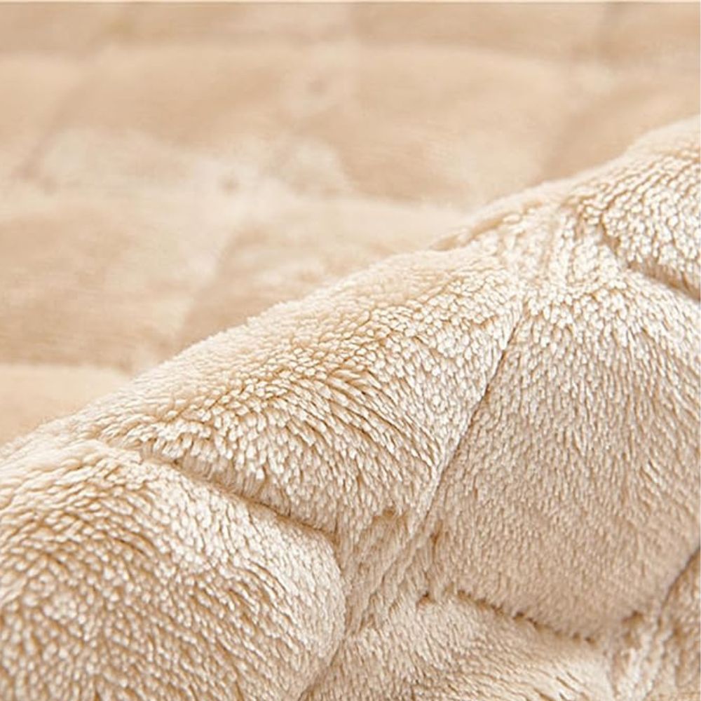 Close-up of a beige quilted microfiber recliner chair cover with a soft, plush texture.