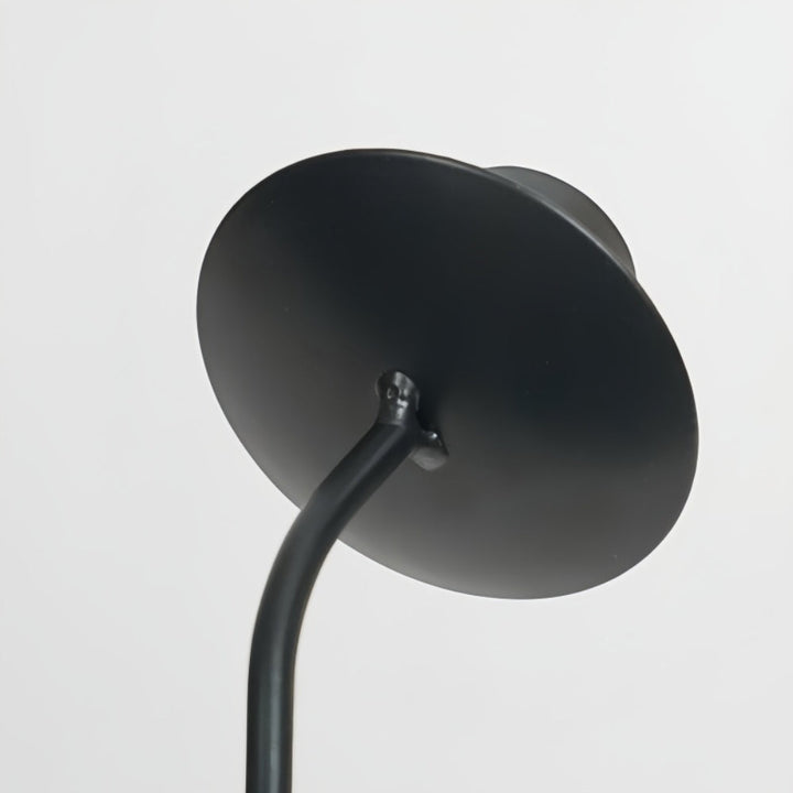 Black lacquered iron candle holder with a wavy, sculptural design.
