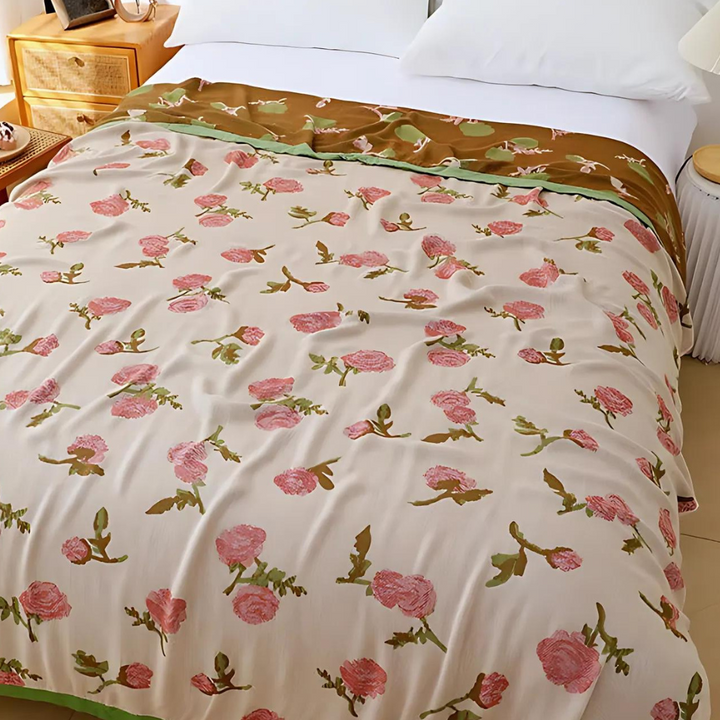 Bamboo fiber cooling blanket with a floral pattern of pink roses on a cream background.