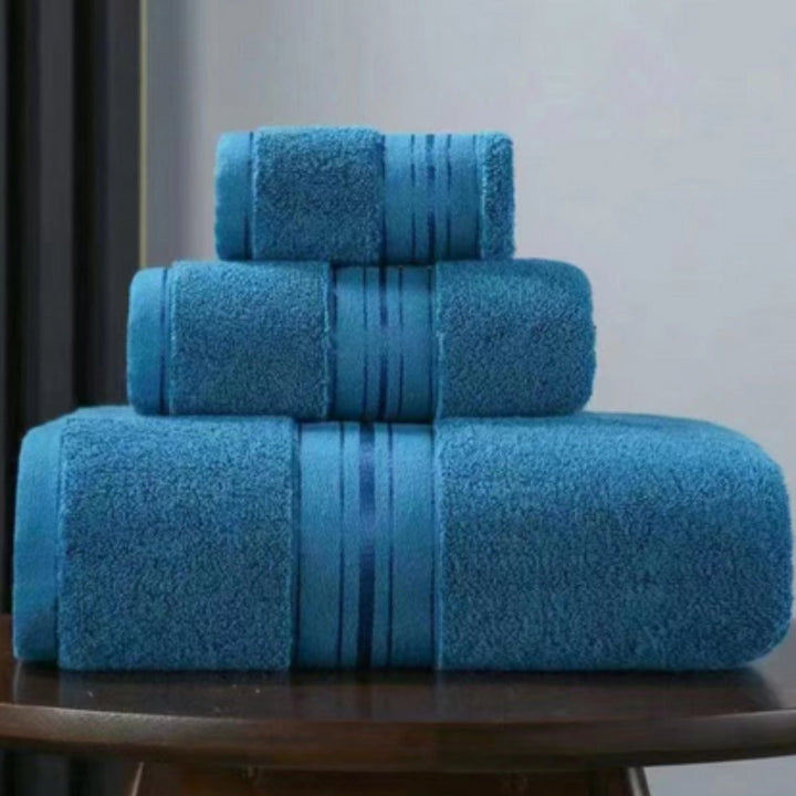 Three stacked blue Egyptian cotton towels with ribbed bands.