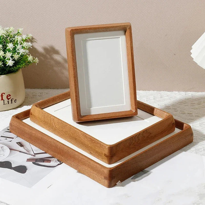 Two handcrafted solid wood photo frames, one standing vertically on a larger tray frame.