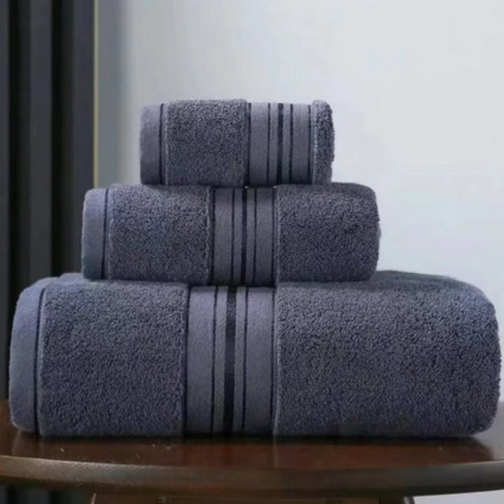 Three stacked charcoal grey Egyptian cotton towels with a subtle striped band.