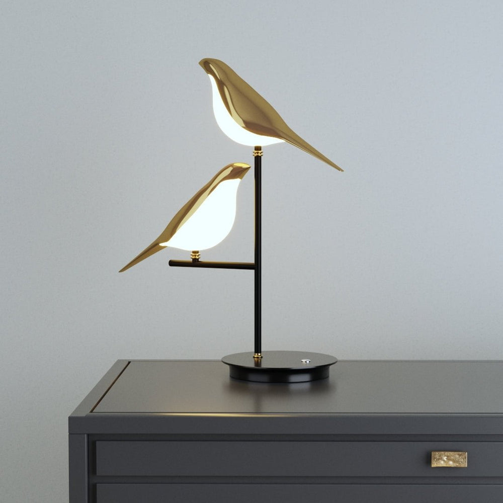 Nordic modern gold bird table lamp with two birds on a black stand.