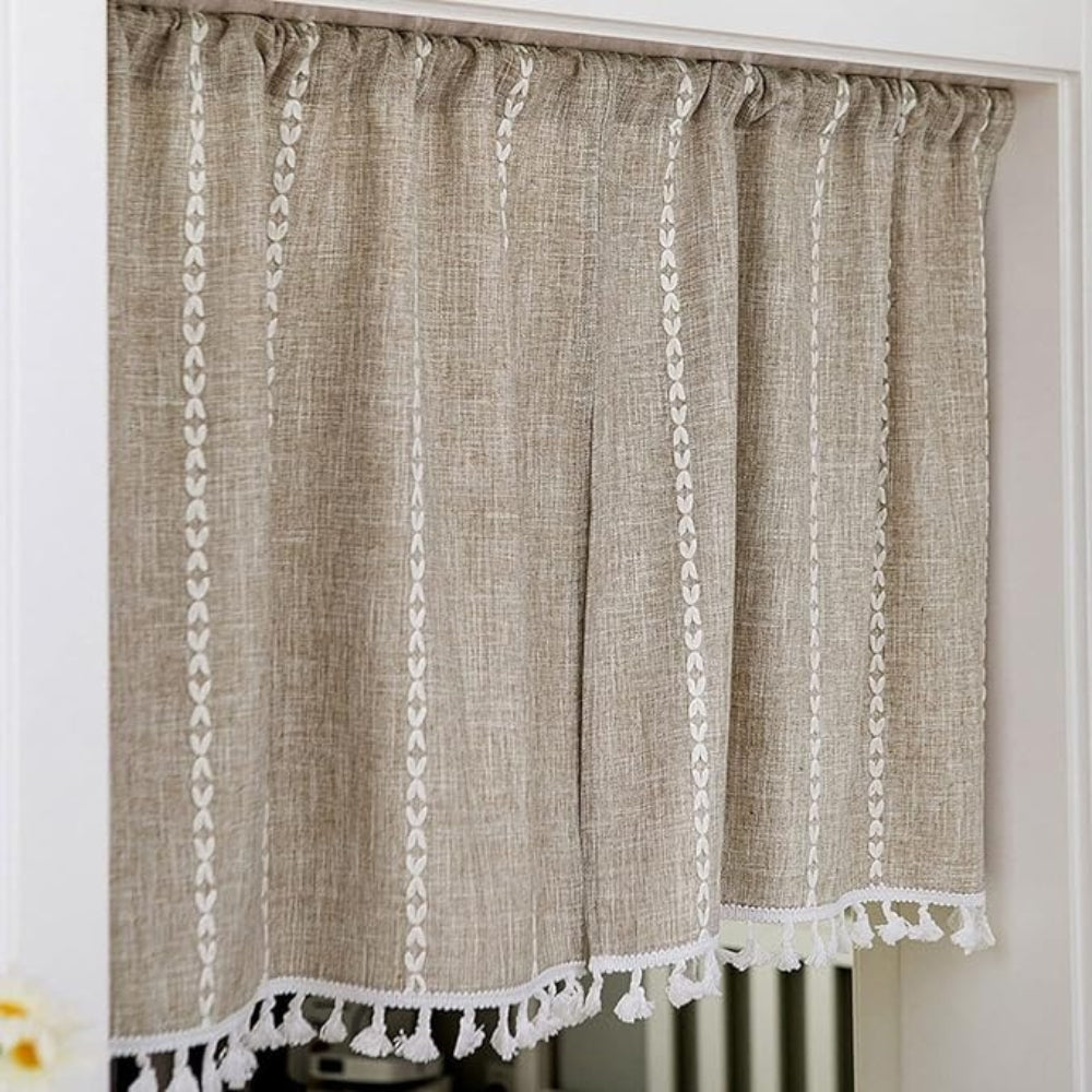 Beige linen-blend kitchen curtain with white embroidered vertical stripes and tassel trim.