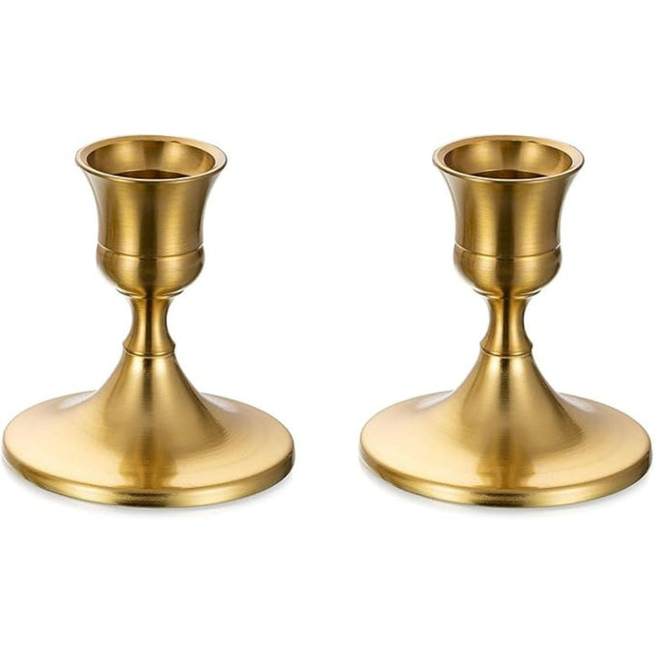 Two gold vintage taper candle holders with a shimmering finish.