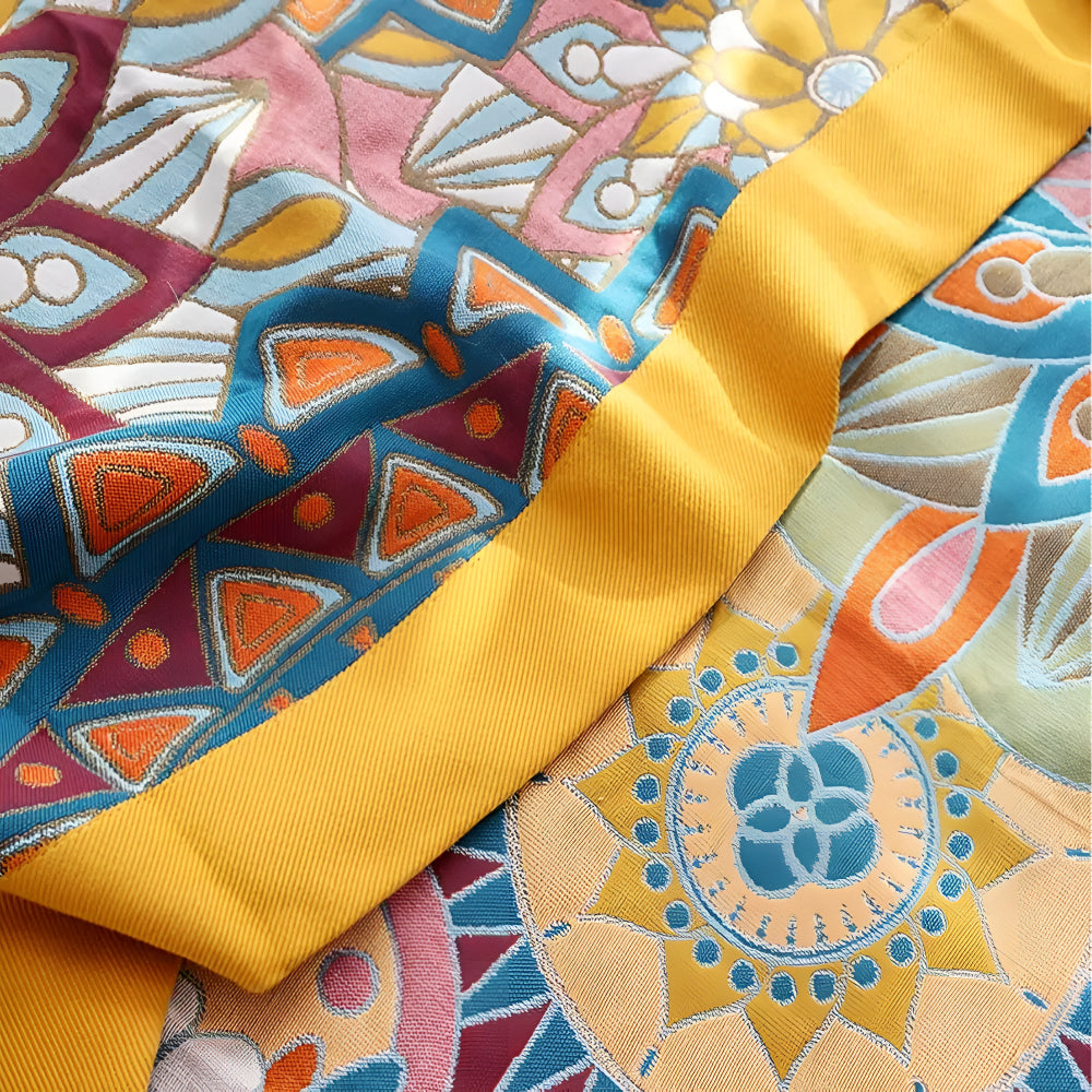 Moroccan floral jacquard cotton blanket with a yellow ribbon accent.