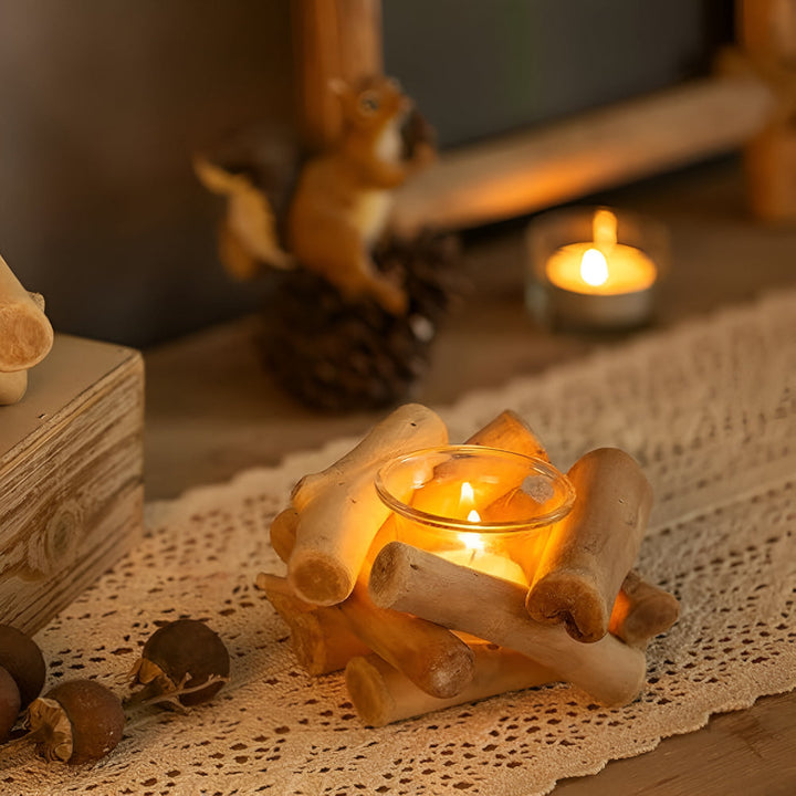 Driftwood tealight holder with a lit candle inside, resting on a lace runner.