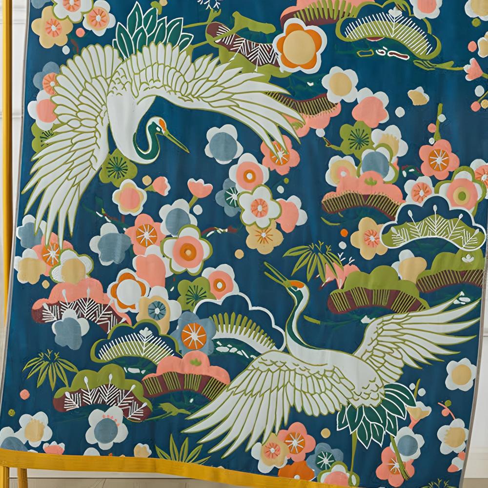 Blue cotton bath towel with a print of white cranes and pink and white flowers.