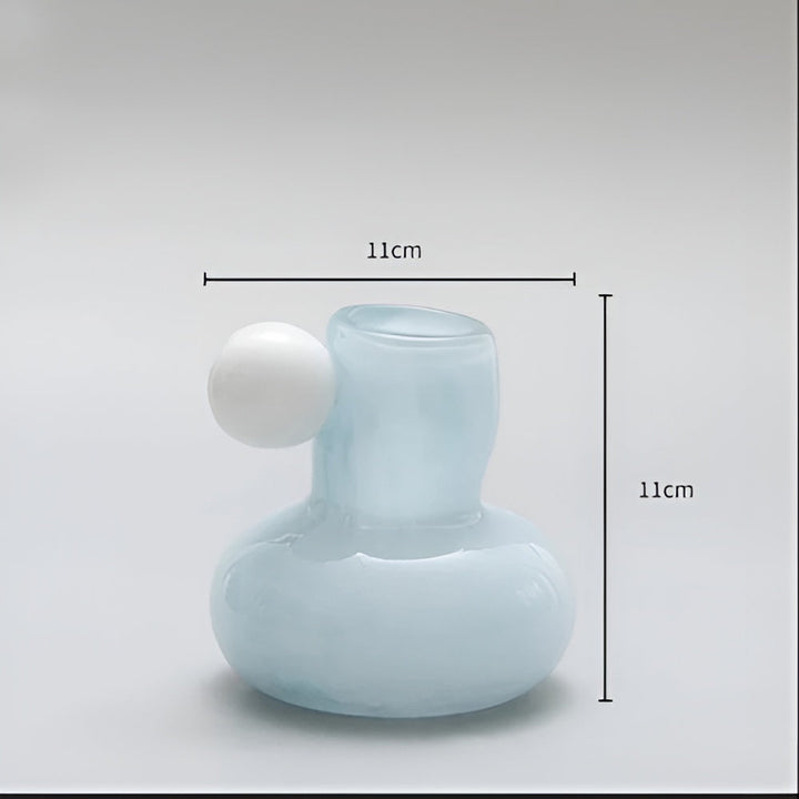 Light blue glass candle holder with a white sphere accent, 11cm wide and 11cm tall.