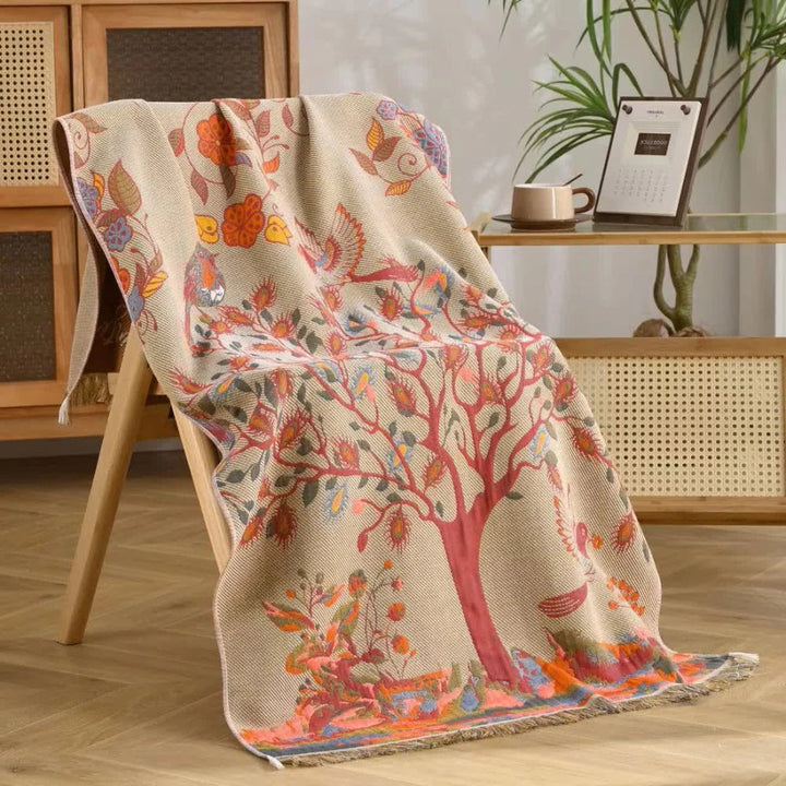 Cotton gauze bath towel with a tree and bird print, featuring a tassel edge.