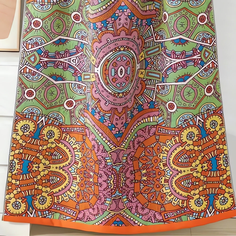A colorful, patterned cotton gauze bath towel with a Moroccan-inspired design in shades of green, pink, orange, and yellow.