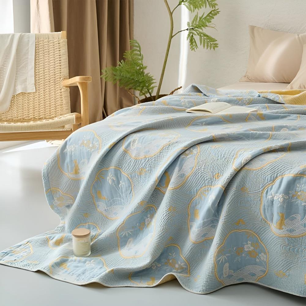 Light blue reversible blanket with a subtle textured pattern and a repeating motif of circular medallions.