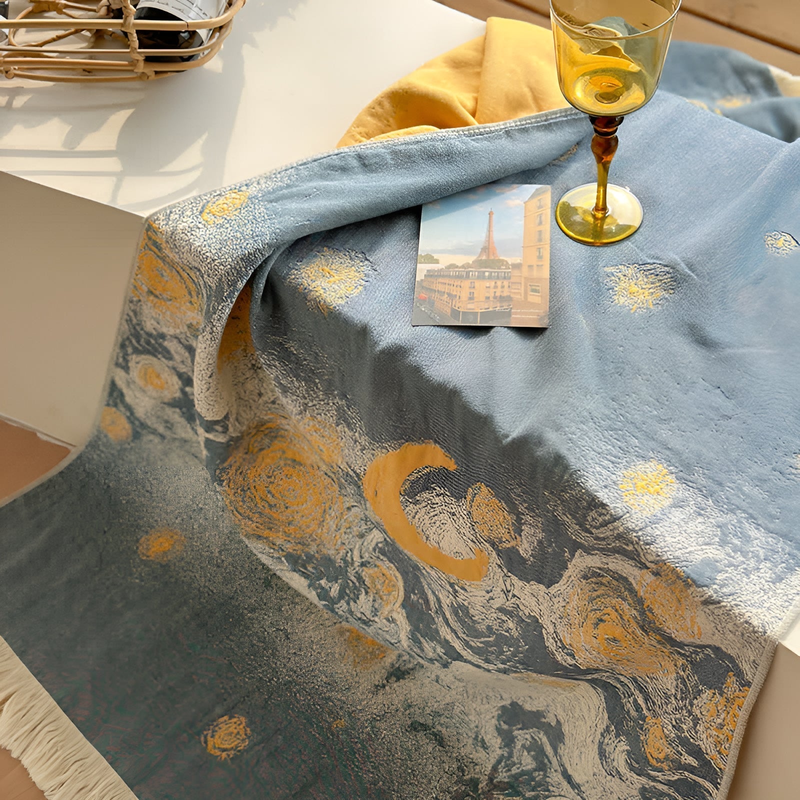Blue cotton bath towel with a swirling starry night pattern and fringed edges.