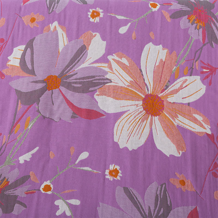 Purple cotton gauze bath towel with a vintage wildflower pattern in shades of pink, white, and gray.