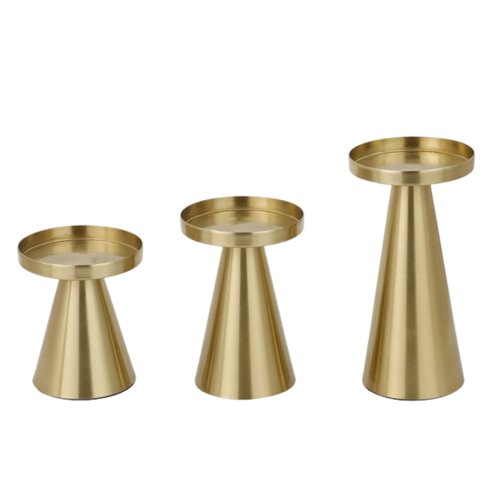 Set of three artisan brass candle holders in varying sizes on a white background.
