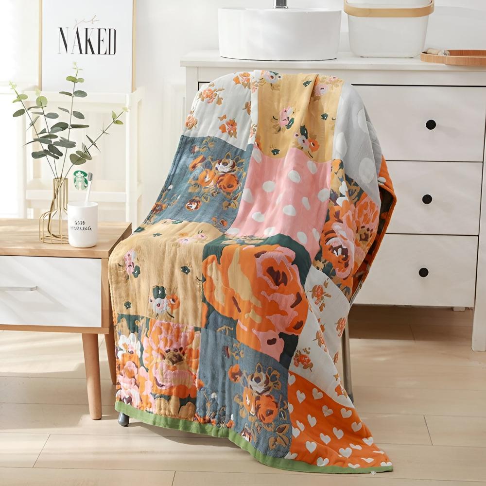 Patchwork cotton bath towel with floral and polka dot prints draped over a chair.