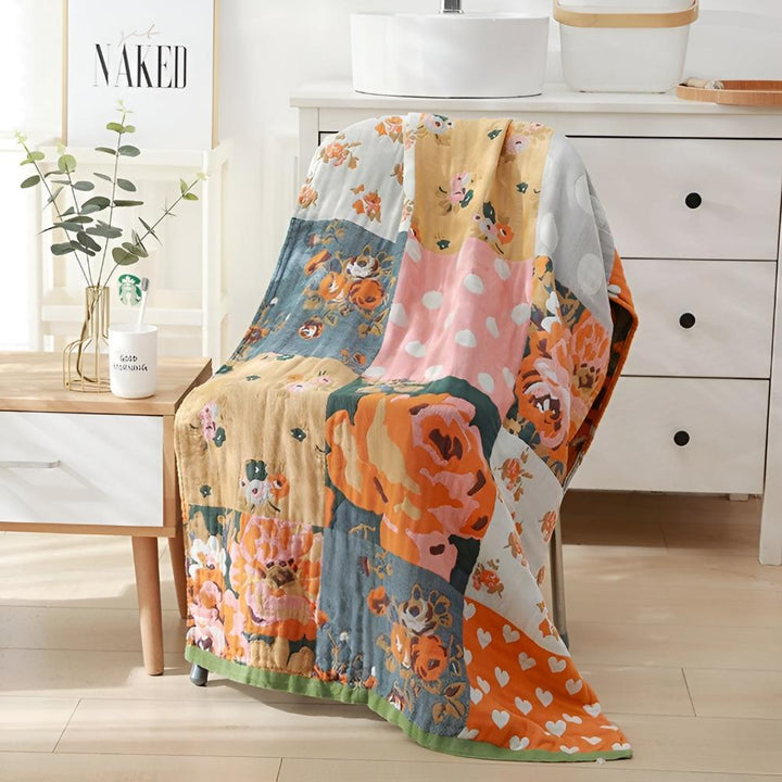 Patchwork cotton bath towel with floral and polka dot prints draped over a chair.