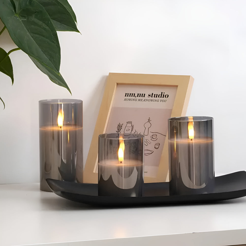 Three grey glass flameless candles with 3D LED flames on a black tray.