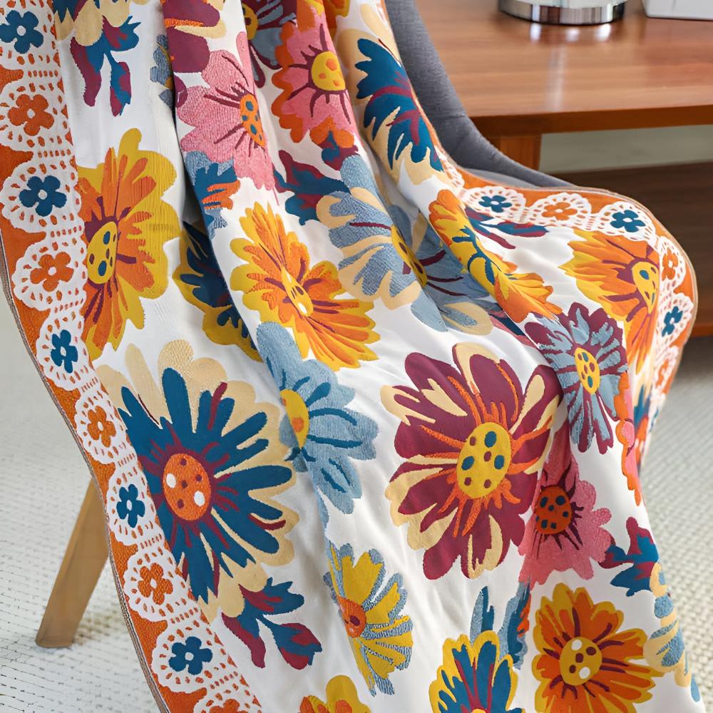 A throw blanket with a vibrant, multi-colored floral pattern draped over a chair.