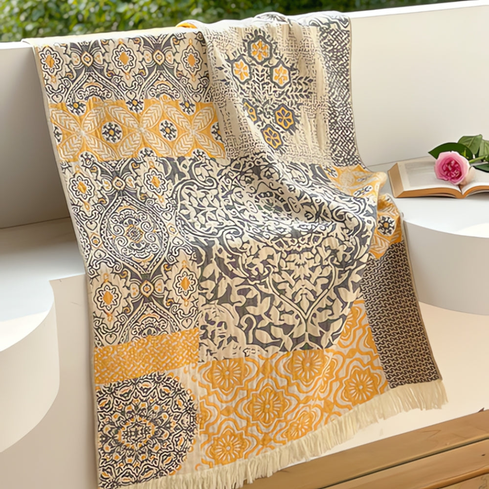 Patchwork pure cotton bath towel with yellow and gray intricate patterns and fringe.