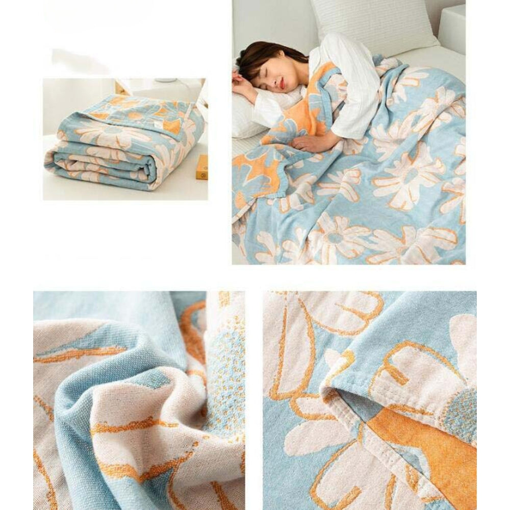 Blue cotton blanket with a daisy pattern, folded and draped over a person sleeping.