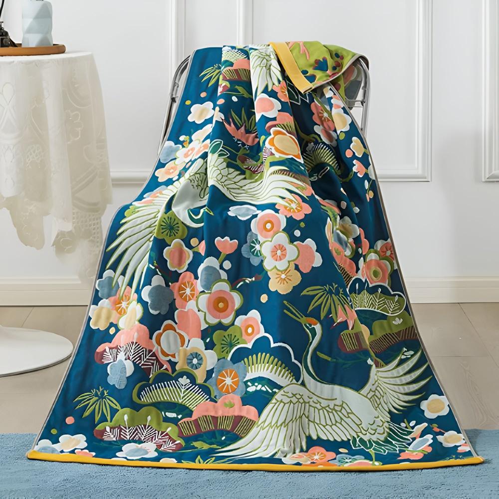 Blue cotton bath towel with a vibrant crane and floral print, featuring red-crowned cranes and colorful blossoms.