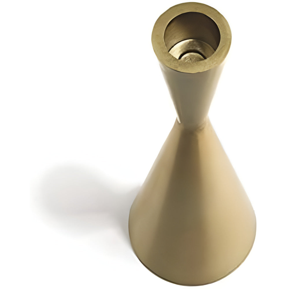 A single brass candlestick with a narrow waist and flared top and bottom, casting a shadow.