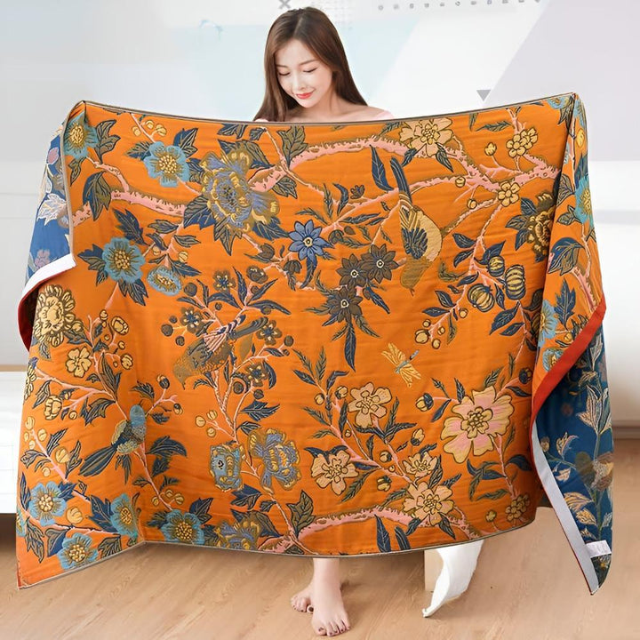 Reversible cotton bath towel with an orange background and a blue floral and bird print.