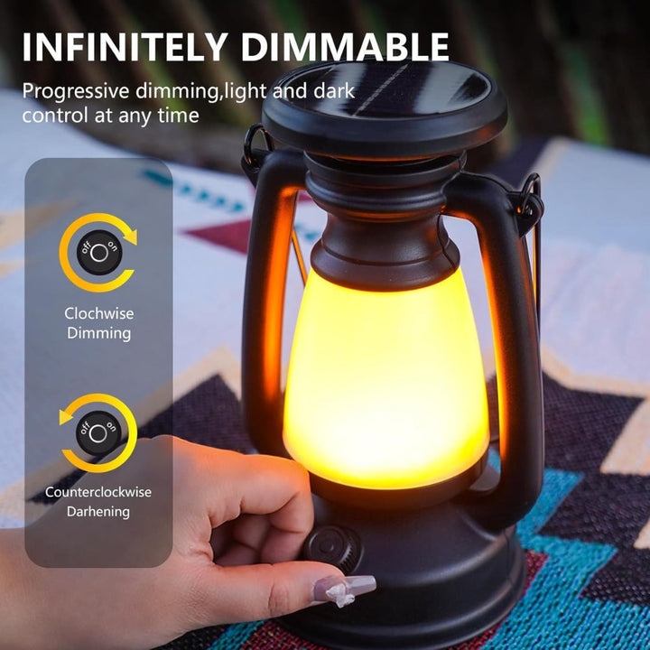 Solar camping lantern with a hand adjusting the brightness knob.