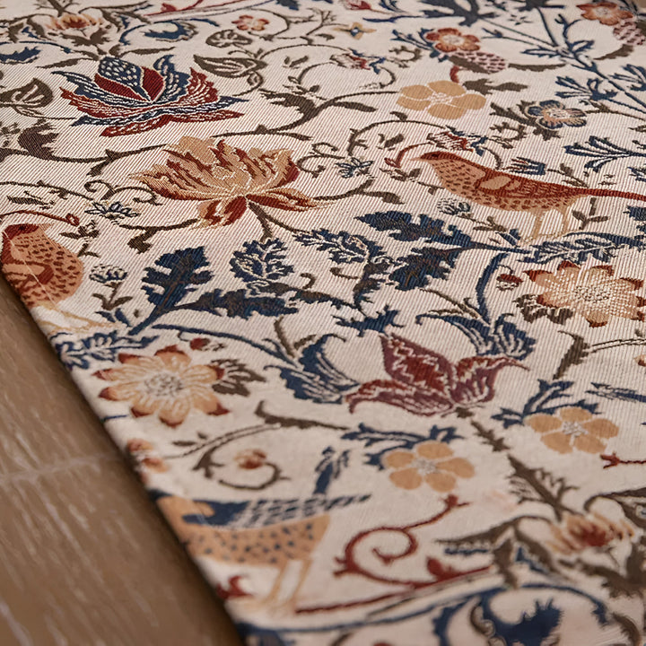 Vintage floral and bird jacquard table runner with a detailed woven pattern.