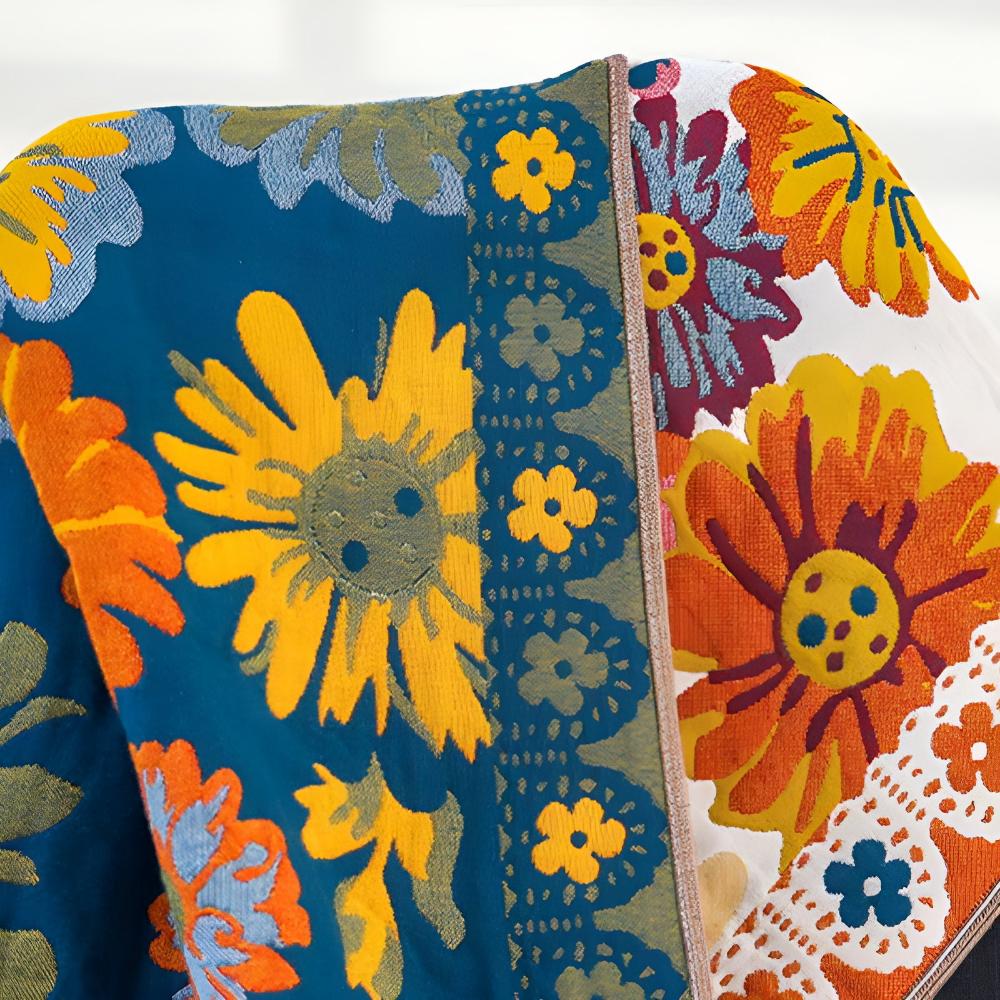 Reversible cotton bath towel with a vibrant blue side featuring large yellow sunflowers and an orange floral border.