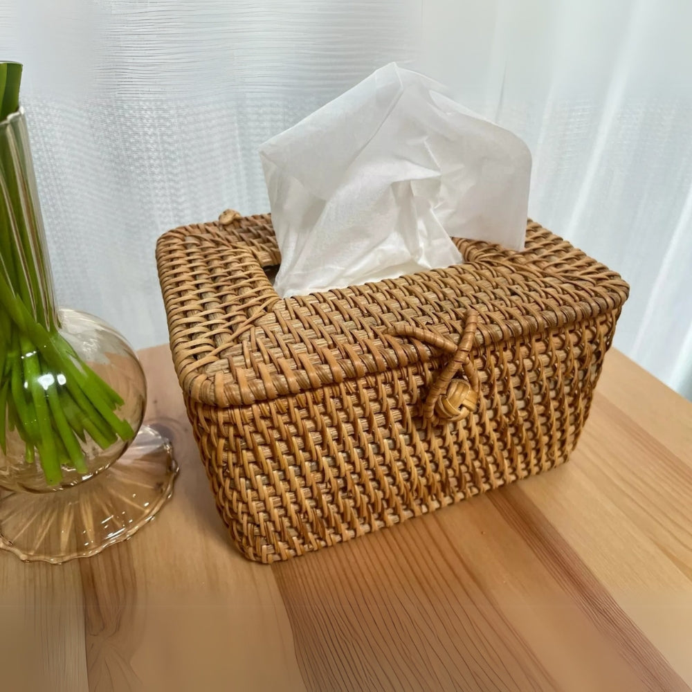 Handwoven rattan tissue box with a loop closure and white tissues peeking out.