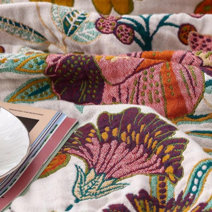 Charm Floral Blanket Throw with a large purple flower and colorful floral patterns.