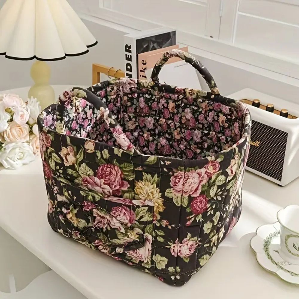 Delicate floral canvas storage basket with handles, open top, and quilted exterior.